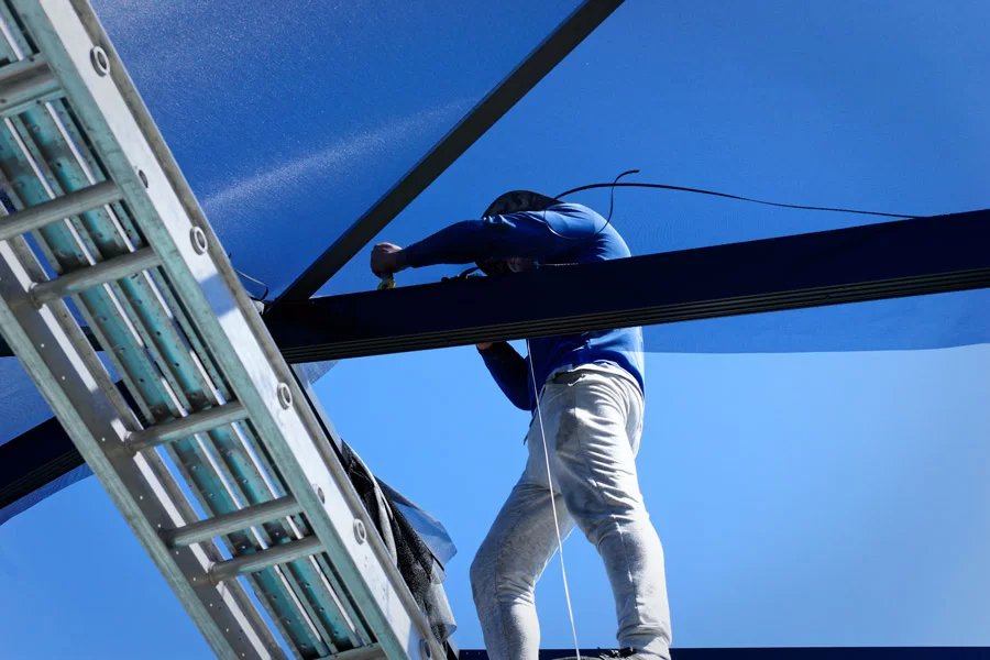 Screen enclosure repair technician working on aluminum frame in New Smyrna, FL